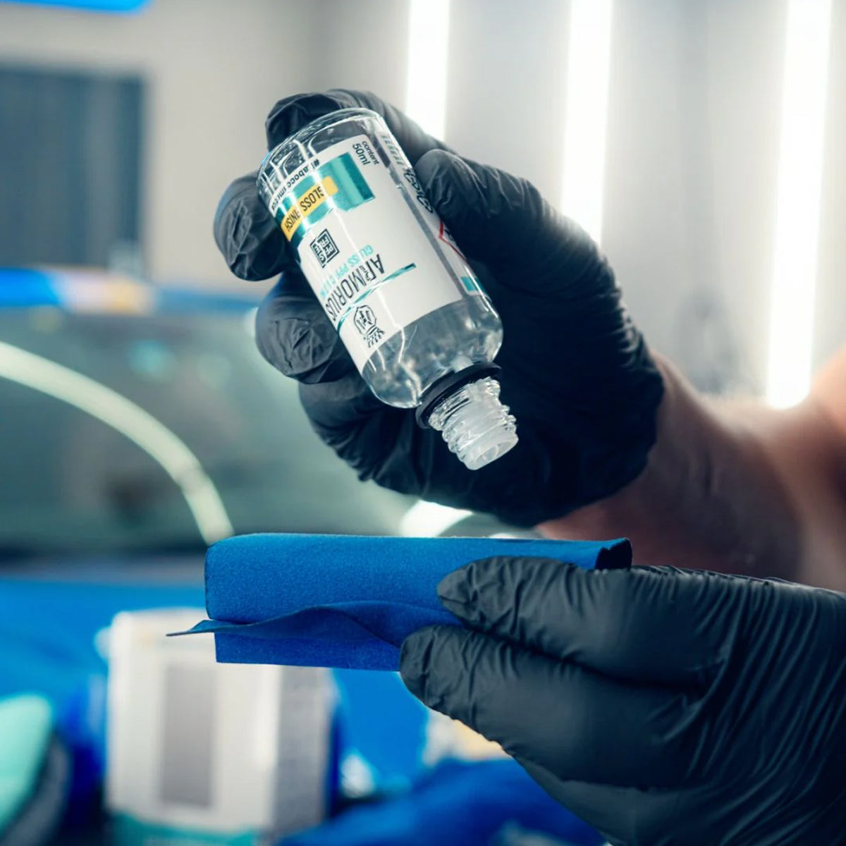 Person wearing gloves holding a Armorius gloss PPF coating