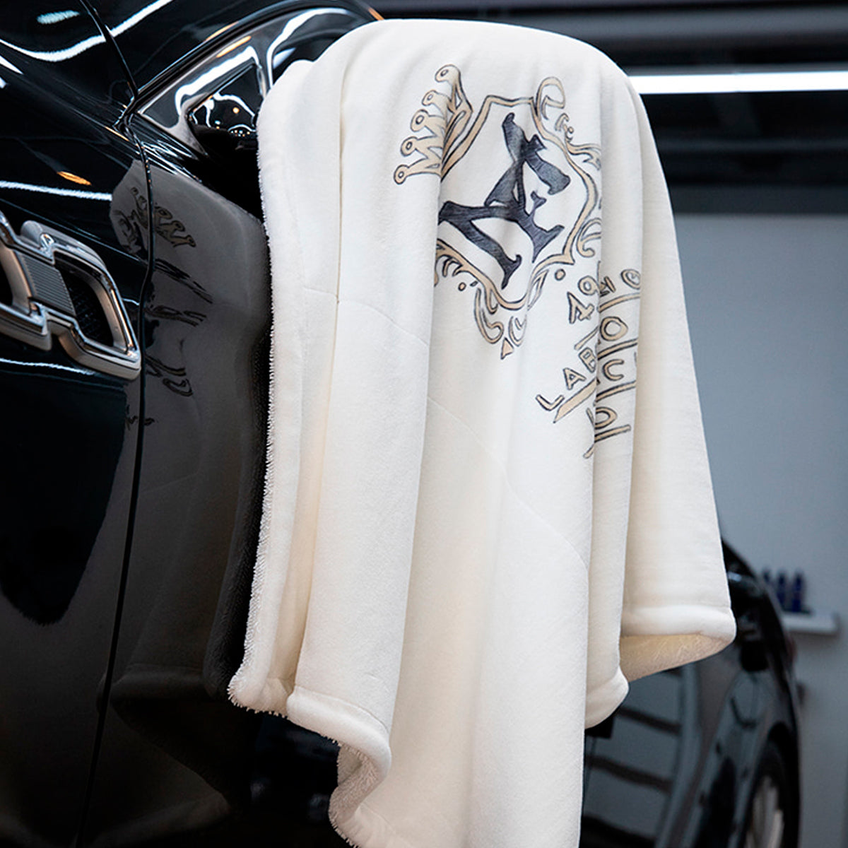 Labocosmetica The Origin Drying Microfibre Towel hanging from car side mirror